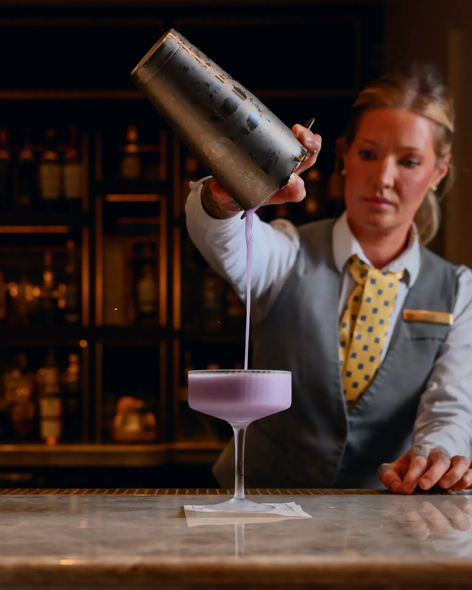 Bartender pouring a purple cocktail at Salt, The Ritz-Carlton Amelia Island